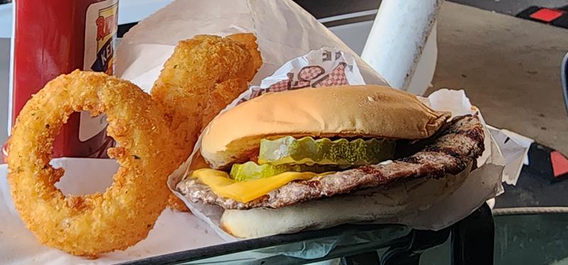 Burger and onion rings on the tray at The Kiltie Drive-In along Highway 16 in Oconomowoc, Wisconsin