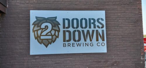 The sign on the side of 2 Doors Down Brewing in Wisconsin Rapids, right along Grand Avenue